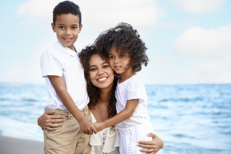 African-American children with mother on sea beachの写真素材