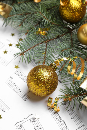 Christmas ball with fir branches and serpentine on note sheets, closeupの写真素材