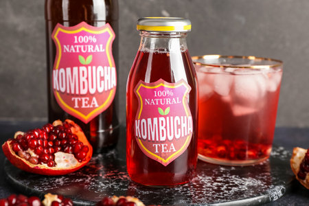 Bottles of fresh kombucha tea on table, closeup