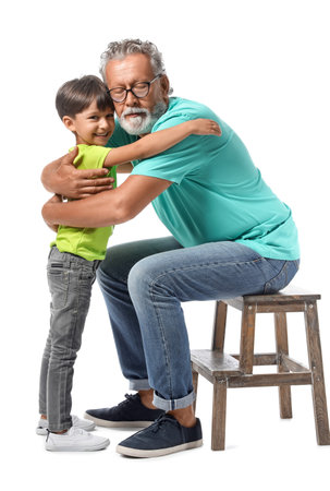 Little boy with his grandfather hugging on white backgroundの写真素材