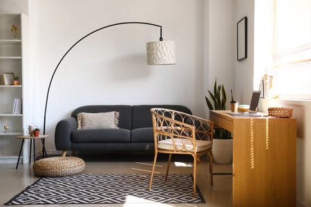 Interior of modern living room with stylish workplace and comfortable sofaの写真素材