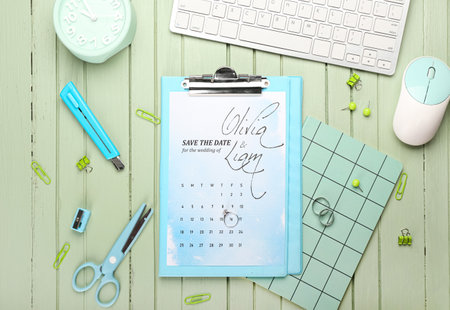 Clipboard with wedding calendar and marked date on color wooden backgroundの写真素材