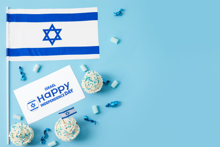Flag of Israel, cupcakes and card with text HAPPY INDEPENDENCE DAY on color backgroundの写真素材