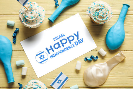 Card with text ISRAEL HAPPY INDEPENDENCE DAY and festive decor on color wooden background, closeupの写真素材