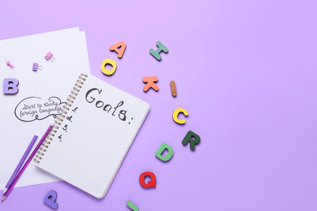 Notebook with empty to do list and paper sheet with text START TO STUDY FOREIGN LANGUAGE on color background. new year goalsの写真素材