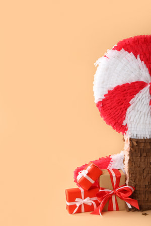 Lollipop pinata with gifts and confetti on color backgroundの写真素材