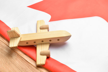 Flag of Canada and airplane on wooden background, closeupの写真素材