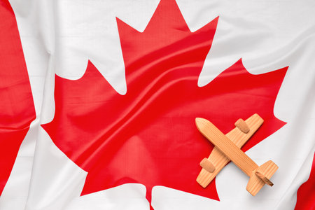 Wooden airplane on flag of Canadaの写真素材