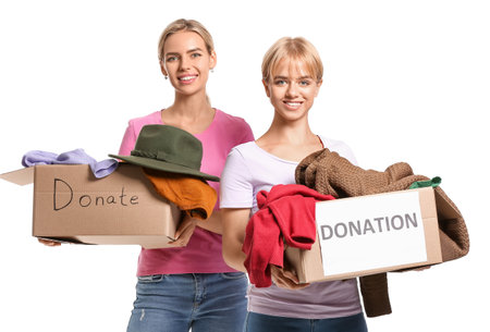Young sisters holding boxes with donations on white backgroundの写真素材