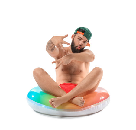 Cool young man with inflatable ring on white backgroundの写真素材