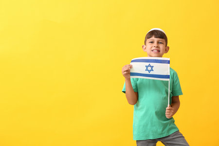 Little boy with the flag of Israel on color backgroundの写真素材
