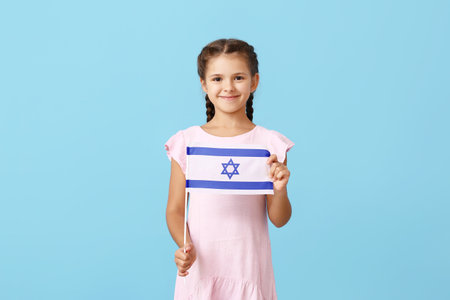 Little girl with the flag of Israel on color backgroundの写真素材