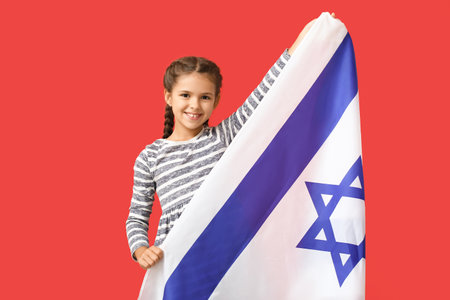 Little girl with the flag of Israel on color backgroundの写真素材