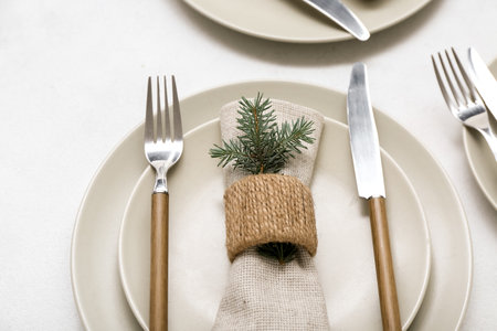 Beautiful table setting with Christmas branches on white background, closeupの写真素材
