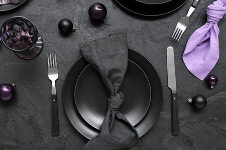 Beautiful table setting with Christmas balls on black background, top viewの写真素材
