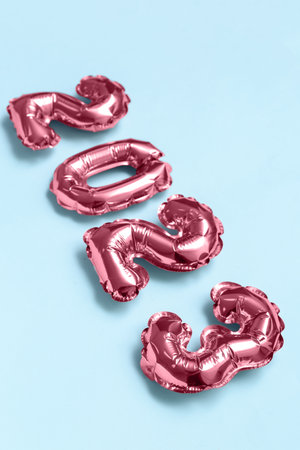 Figure 2023 made of foil balloons on blue background