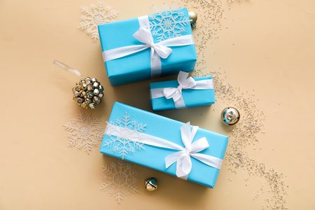 Composition with Christmas gifts, decorations and sequins on color background