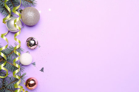 Composition with Christmas decorations, fir branches and serpentine on color backgroundの写真素材