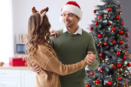 Loving couple dancing in the kitchen on Christmas eveの写真素材