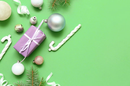 Composition with Christmas gift and beautiful decorations on color backgroundの写真素材
