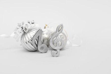 Note signs with Christmas balls, snowflake and ribbon on gray backgroundの写真素材