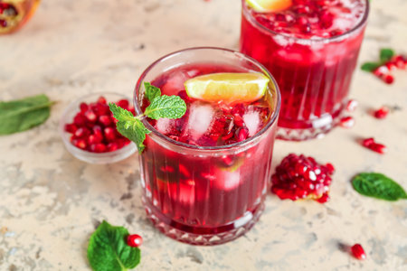 Glasses of cold pomegranate juice on color background, closeupの写真素材