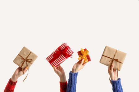 Women with beautiful Christmas gift boxes on white background