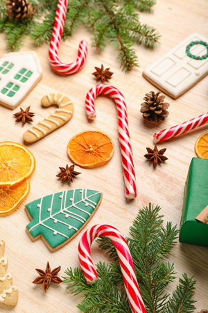 Composition with sweet candy canes, cookies and spices on wooden backgroundの写真素材