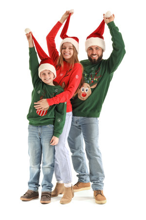 Happy parents with their little son in Santa hats on white backgroundの写真素材