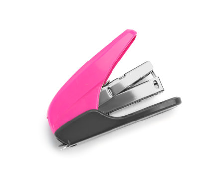 Pink office stapler isolated on white background