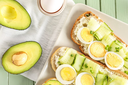 Plate of tasty toasts with boiled egg on color wooden background, closeupの写真素材