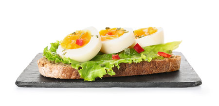 Board delicious toast with boiled egg on white background