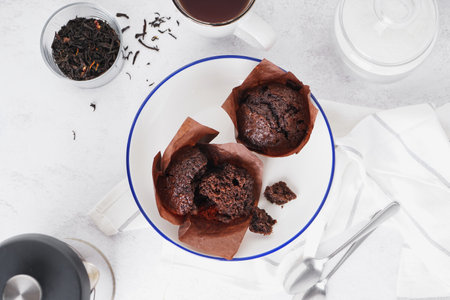 Plate of sweet chocolate muffins on light tableの写真素材