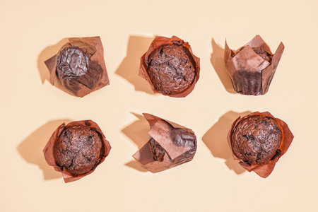 Delicious chocolate muffins on color backgroundの写真素材