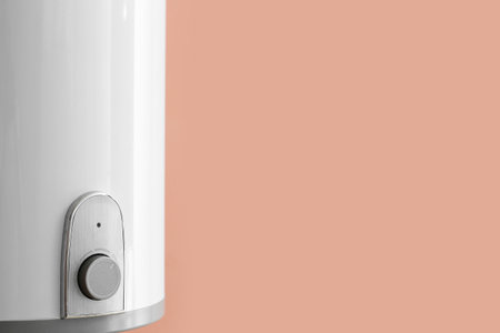 Modern electric boiler on color wall, closeupの写真素材