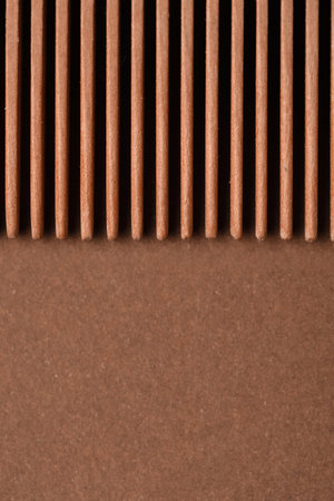 Close up view of wooden hair comb on brown backgroundの写真素材