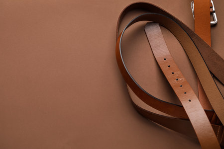 Leather belts on brown backgroundの写真素材