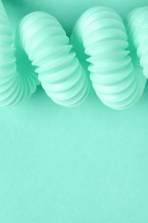 Closeup view of spiral corrugated tubing on mint backgroundの写真素材