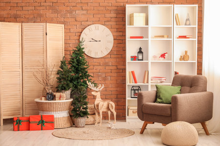 Interior of living room with clocks, Christmas trees and wooden reindeerの写真素材