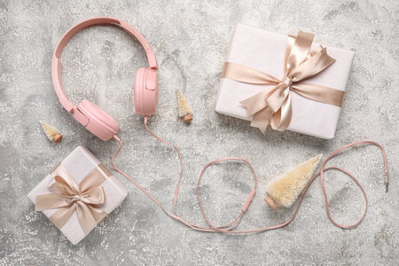 Composition with modern headphones, Christmas gifts and decorations on grunge backgroundの写真素材