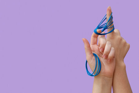 Woman with blue rubber bands on lilac background