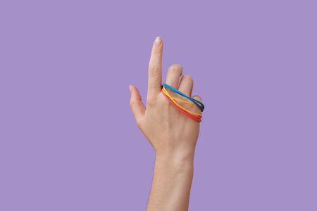 Woman with rubber bands on lilac background