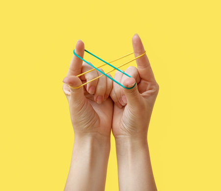 Woman with rubber bands on yellow background