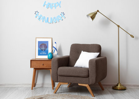 Interior of light room with armchair and flag of Israel decorated for Hanukkah celebrationの写真素材