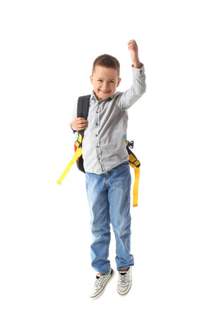 Jumping little schoolboy on white backgroundの写真素材