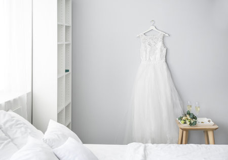 Interior of bedroom with beautiful wedding dress prepared for ceremonyの写真素材