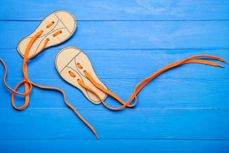 Shoe lacing cards with long laces on color wooden backgroundの写真素材