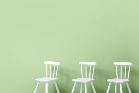 White chairs for children on green backgroundの写真素材