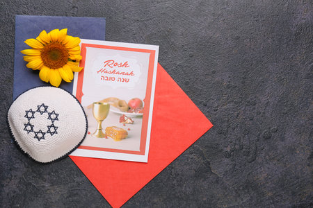 Greeting card for Rosh hashanah (Jewish New Year) with kipa and envelopes on dark background