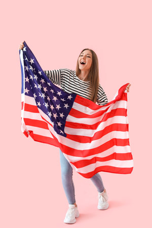 Beautiful woman with USA flag on pink backgroundの写真素材